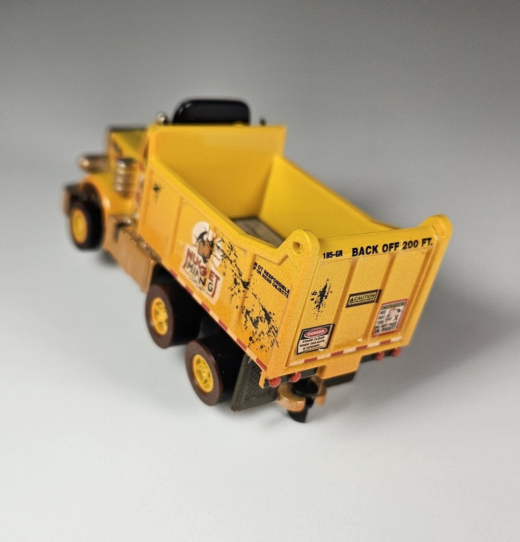 Auto World AMP Xtraction Peterbilt 359 Dump Truck (Yellow) with Working Headlights HO Scale Slot Car