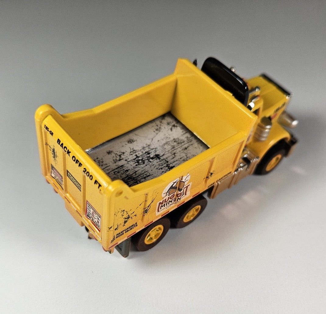 Auto World AMP Xtraction Peterbilt 359 Dump Truck (Yellow) with Working Headlights HO Scale Slot Car